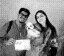 a photo of a couple holding a dog shot with a Game Boy Camera
