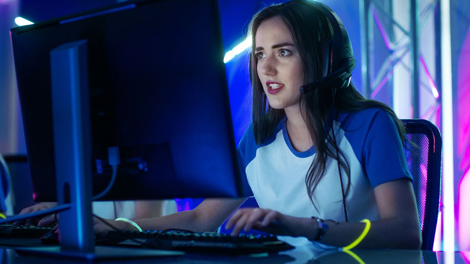 Woman gaming on PC with RGB lights in the background