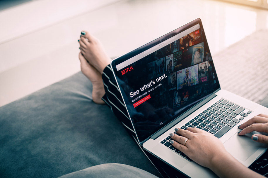 woman using Netflix on laptop