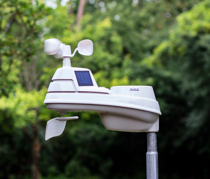 AcuRite outdoor weather sensor in a backyard