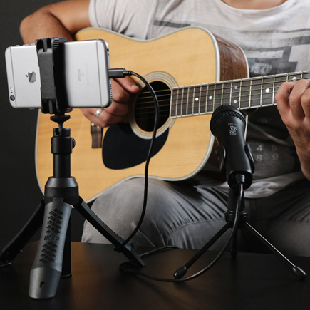 Guitar player connected to the IK Multimedia iRig Mic HD 2 on a tripod