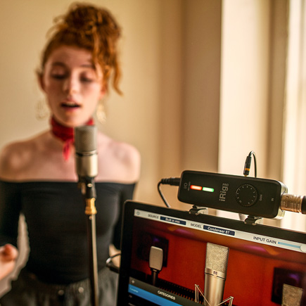 Female vocalist recording with the IK Multimedia iRig Pro I/O Portable Audio & MIDI Interface