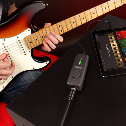  Guitar player connected to IK Multimedia iRig Pro I/O Portable Audio & MIDI Interface and an amp