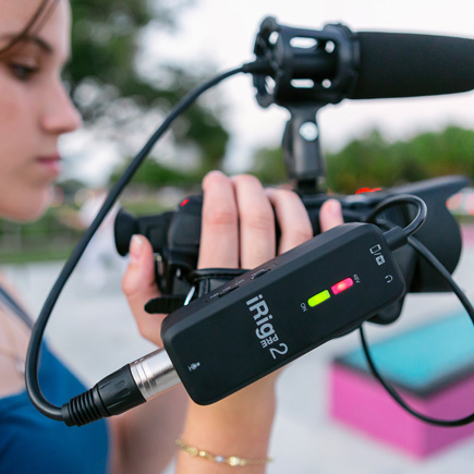Girl recording with the IK Multimedia iRig Pre 2