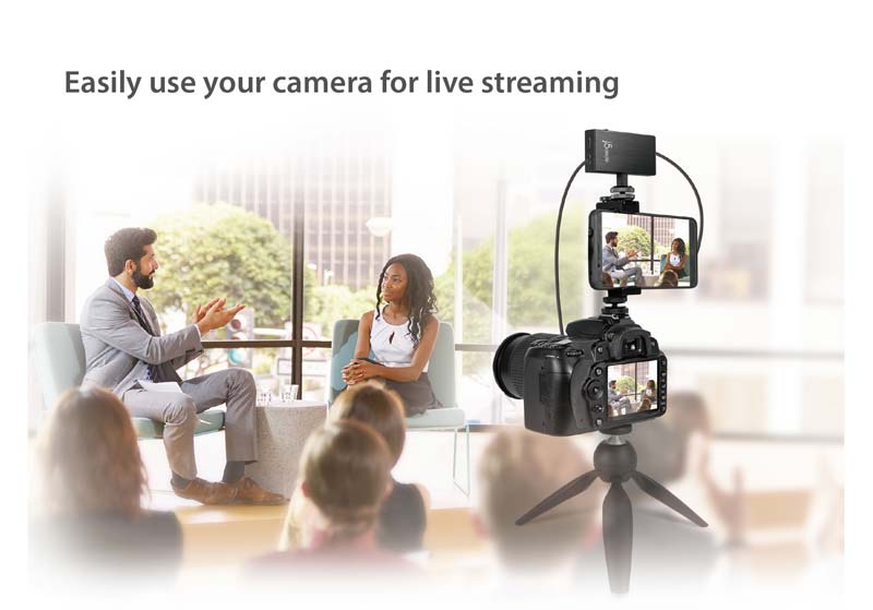 Easily use your camera for live streaming. Image of camera filming interview.