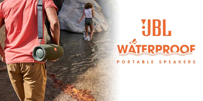 Hikers beside a stream listening to their JBL Xtreme 2 waterproof portable speaker