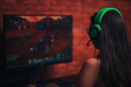 girl wearing headphones engaged in gaming
