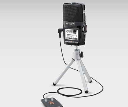 Image of the Zoom H2n Recorder on a tripod stand with cable and controller