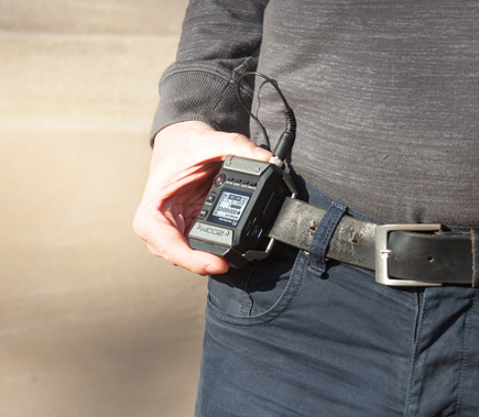 Zoom F1 Field Digital Recorder clipped to the belt on a guy's waist