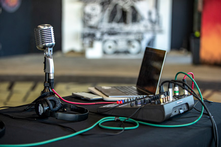 The Zoom LiveTrak L-8 Portable 8-Channel Digital Mixer and Multitrack Recorder connected to a microphone and a laptop