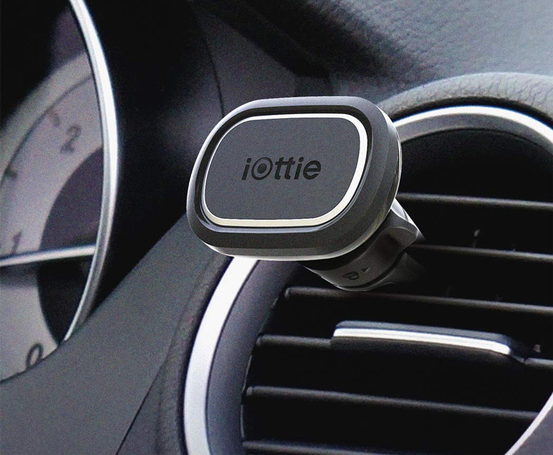 iOttie magnetic phone mount with phone mounted on a car dashboard vent