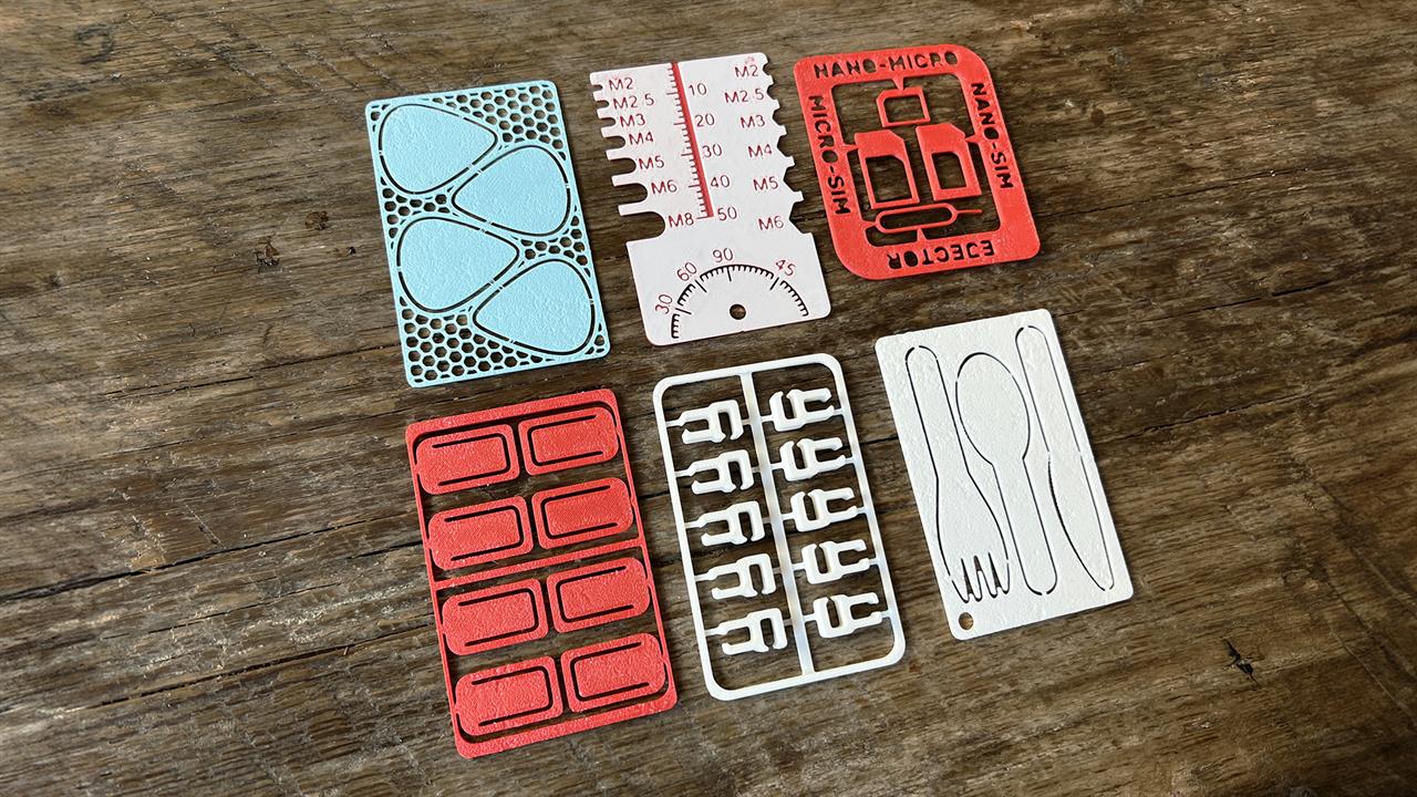 A series of 3D printed card kits on a wood table. 