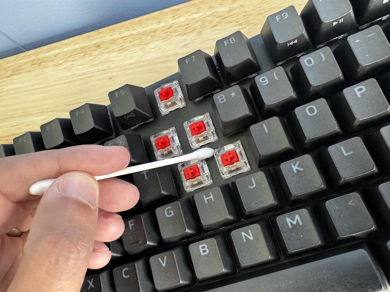 a keyboard being cleaned, missing 5 keys