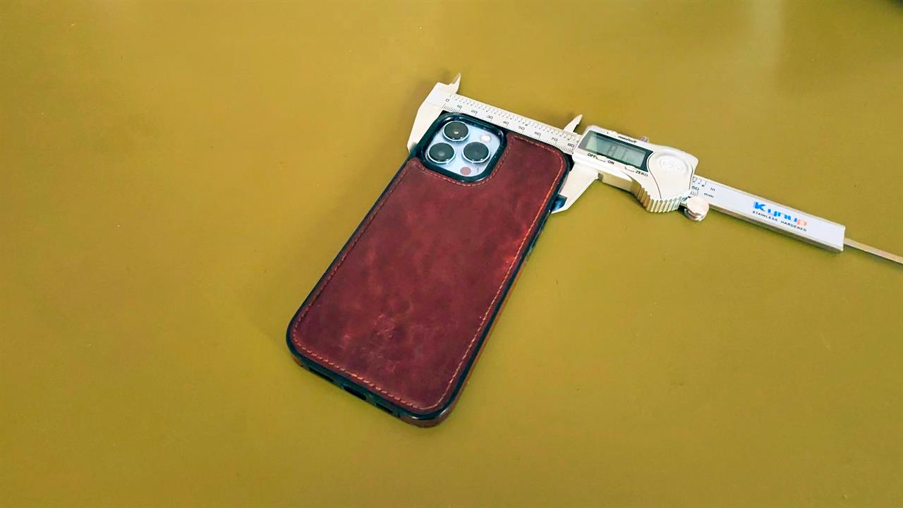 Calipers measuring an iPhone case. 