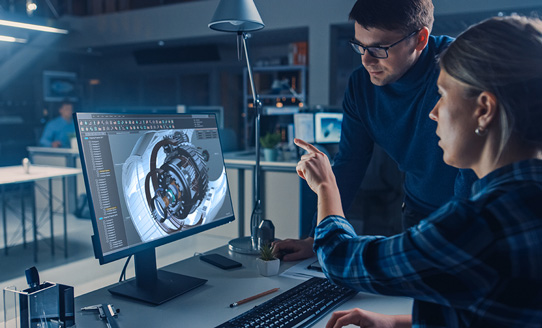 Team members viewing monitor