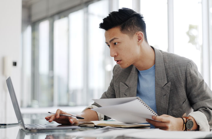 Man at desk reviewing Member Pricing options